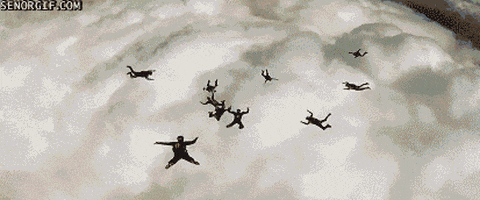 skydivers track through a cloud